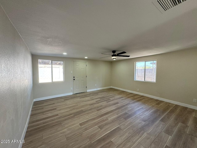 unfurnished room with hardwood / wood-style floors and ceiling fan