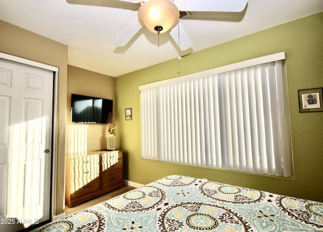 bedroom featuring ceiling fan and a closet