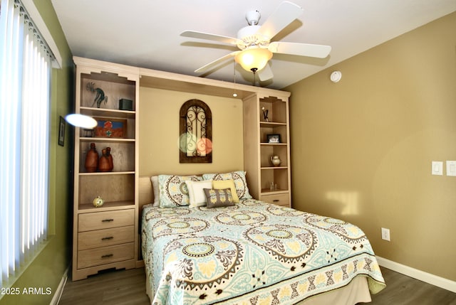 bedroom with dark hardwood / wood-style floors and ceiling fan