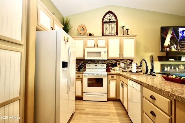 kitchen with lofted ceiling, sink, white appliances, light hardwood / wood-style flooring, and tasteful backsplash