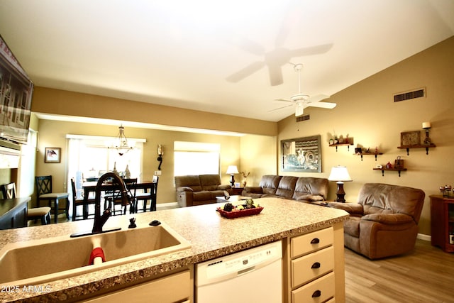 kitchen with lofted ceiling, sink, light wood-type flooring, white dishwasher, and ceiling fan