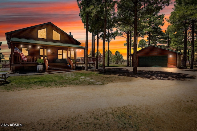 2295 Bison Ranch Trl, Overgaard, AZ 85933 - view of front of home with an outdoor structure, a detached garage, a porch, and faux log siding