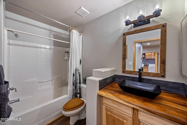 2295 Bison Ranch Trl, Overgaard, AZ 85933 - full bath featuring washer / dryer, shower / bathtub combination with curtain, vanity, and a textured wall