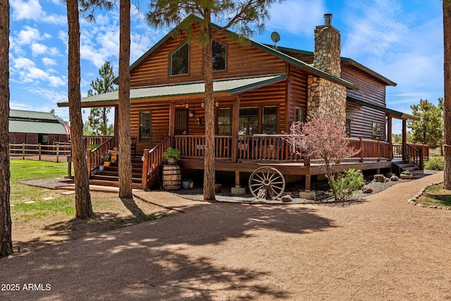 2295 Bison Ranch Trl, Overgaard, AZ 85933 - rear view of property featuring a chimney, log veneer siding, and a metal roof