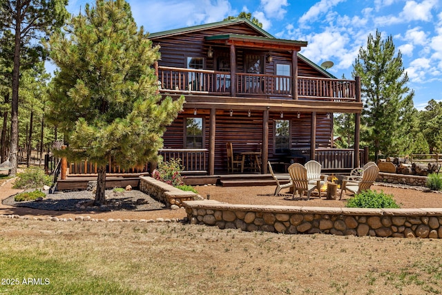 2295 Bison Ranch Trl, Overgaard, AZ 85933 - rear view of property featuring a patio, a fire pit, log exterior, and a wooden deck