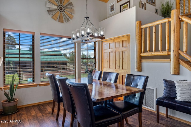 2295 Bison Ranch Trl, Overgaard, AZ 85933 - dining area with a towering ceiling, a chandelier, healthy amount of natural light, and wood finished floors