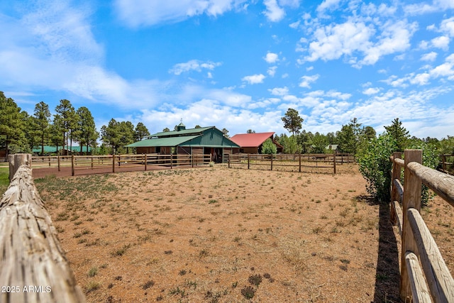 2295 Bison Ranch Trl, Overgaard, AZ 85933 - view of yard with an outdoor riding arena, an exterior structure, a rural view, and an outbuilding