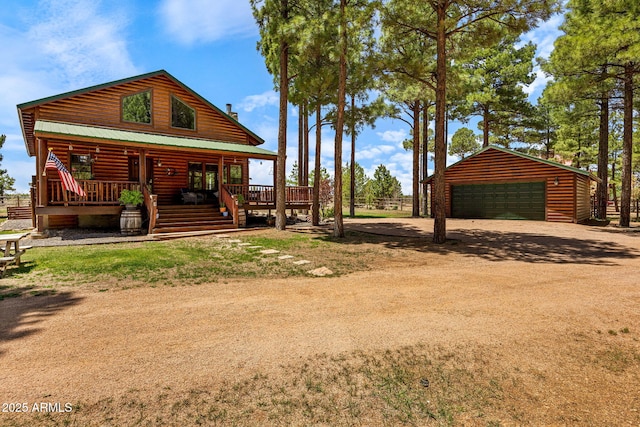 2295 Bison Ranch Trl, Overgaard, AZ 85933 - view of yard featuring a detached garage, an outdoor structure, covered porch, and dirt driveway