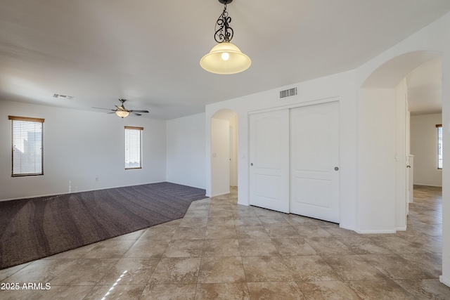 unfurnished room with ceiling fan