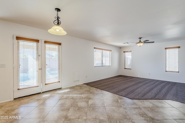 unfurnished room featuring french doors, ceiling fan, and light tile patterned floors