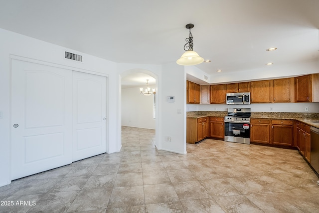 kitchen featuring stainless steel appliances and decorative light fixtures