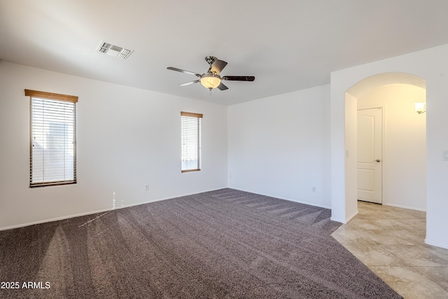 unfurnished room with ceiling fan and light carpet