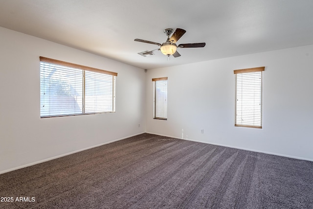 carpeted spare room featuring ceiling fan