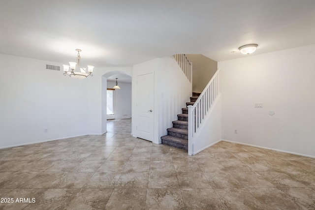 spare room with a chandelier