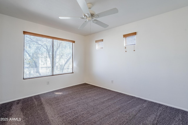 empty room with ceiling fan and carpet