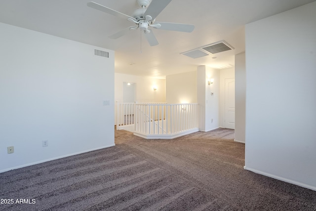 unfurnished room with ceiling fan and carpet