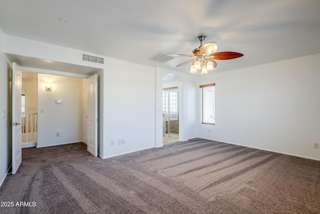 unfurnished bedroom with ceiling fan and dark colored carpet