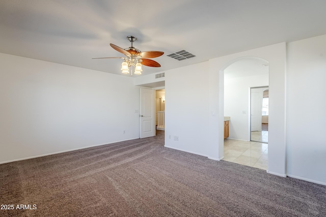 spare room with ceiling fan and light colored carpet