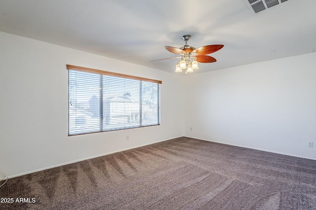 carpeted spare room featuring ceiling fan