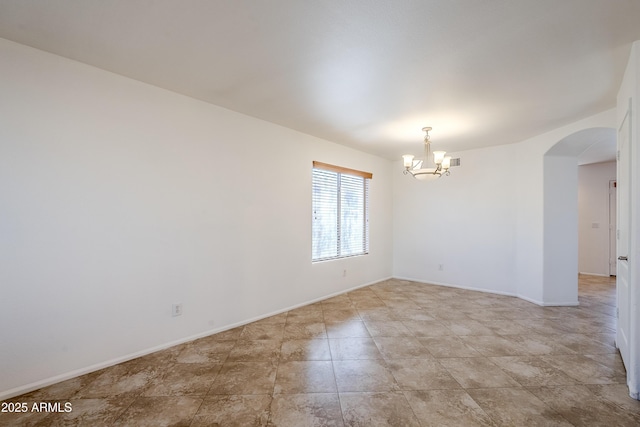 empty room with an inviting chandelier