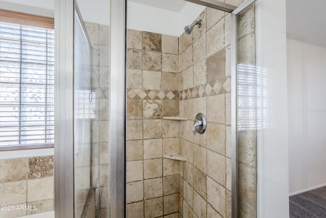 bathroom with a shower with door