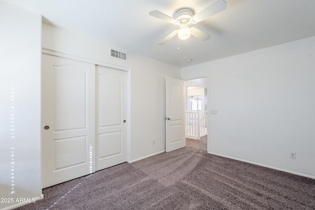 unfurnished bedroom featuring ceiling fan, carpet flooring, and a closet