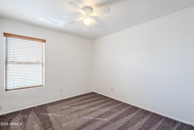 carpeted spare room featuring ceiling fan