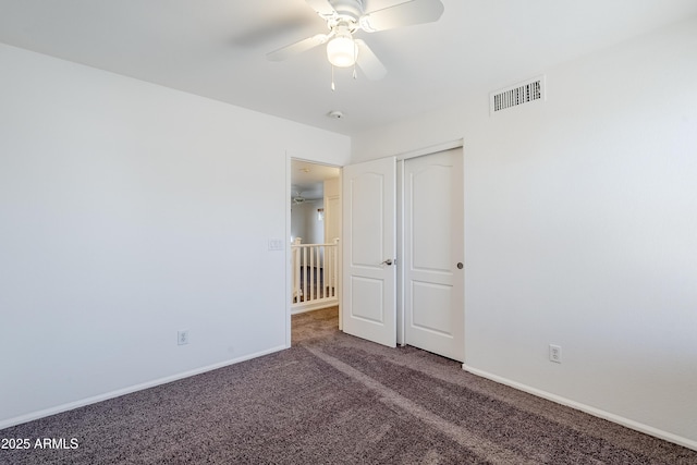 carpeted spare room with ceiling fan