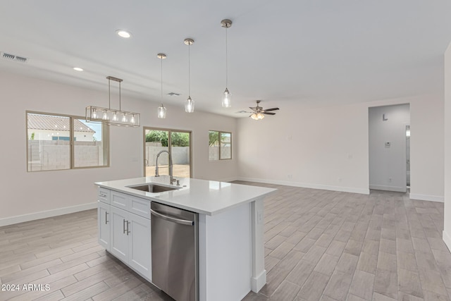 kitchen with a kitchen island with sink, stainless steel dishwasher, white cabinets, sink, and light hardwood / wood-style flooring