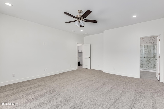 carpeted spare room with ceiling fan