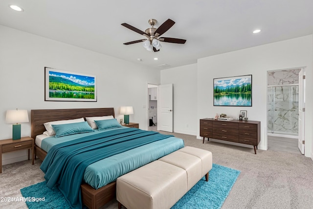 bedroom with light carpet, ceiling fan, and ensuite bathroom