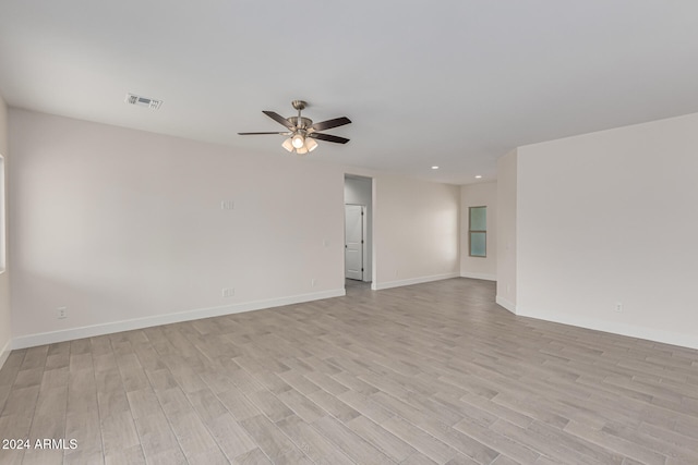 empty room with light wood-type flooring and ceiling fan