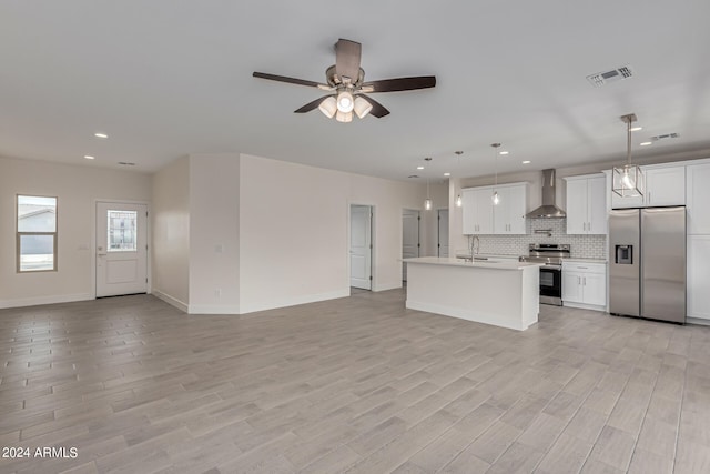 unfurnished living room with ceiling fan, light wood-type flooring, and sink