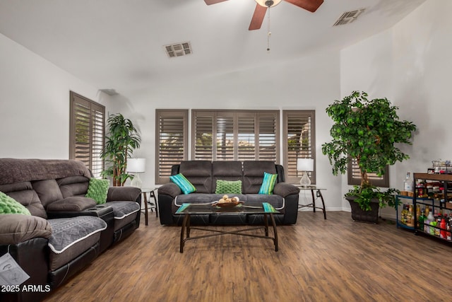 living area featuring a ceiling fan, baseboards, visible vents, and wood finished floors