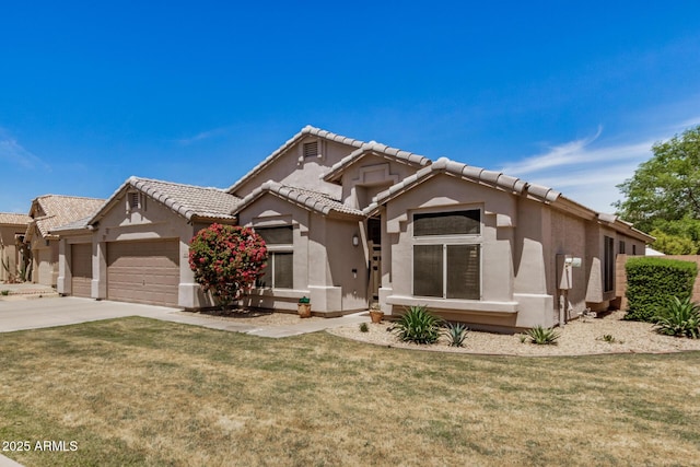 view of front of house featuring a front lawn, stucco siding, a tiled roof, concrete driveway, and an attached garage