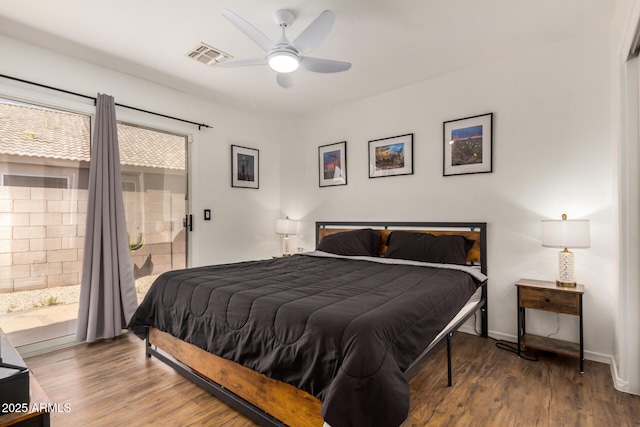 bedroom featuring visible vents, wood finished floors, access to exterior, baseboards, and a ceiling fan