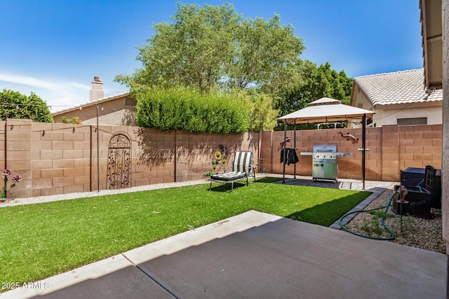 view of yard with a fenced backyard, a gazebo, and a patio area