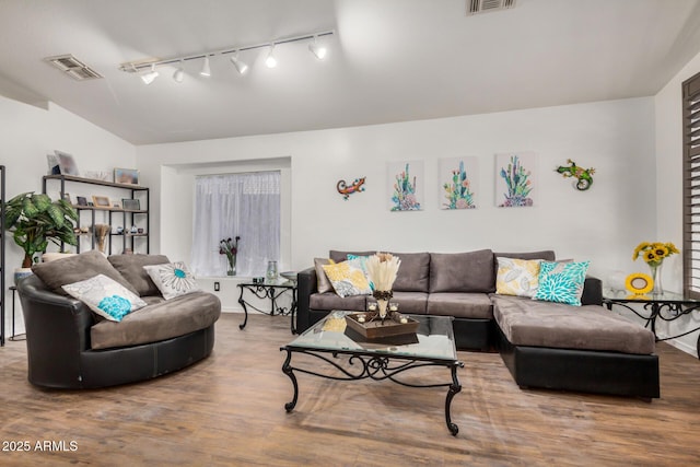 living area featuring track lighting, wood finished floors, and visible vents