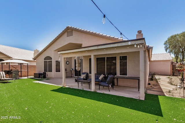 back of house featuring a chimney, a patio area, fence, outdoor lounge area, and stucco siding