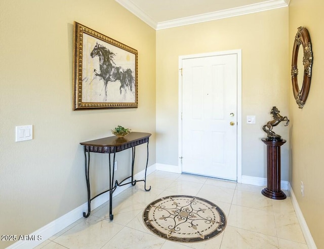 foyer with ornamental molding and baseboards