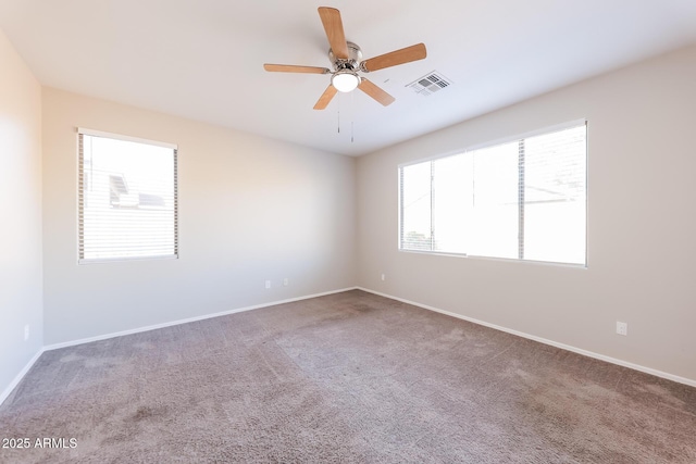 unfurnished room with ceiling fan and carpet flooring