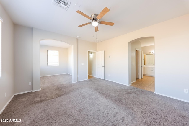 carpeted empty room featuring ceiling fan