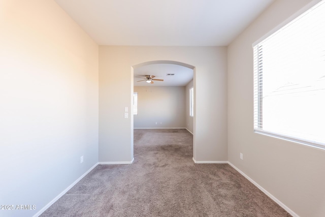 carpeted spare room with ceiling fan