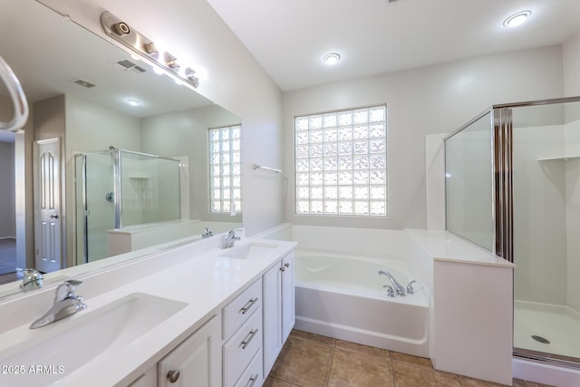 bathroom featuring shower with separate bathtub, vanity, and tile patterned flooring