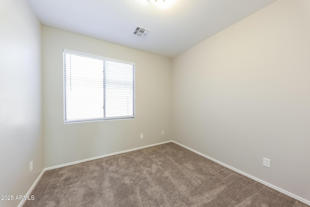 spare room featuring light colored carpet