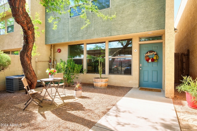 doorway to property with a patio area and central AC unit