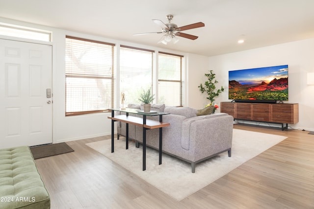 living room featuring light wood-type flooring and ceiling fan