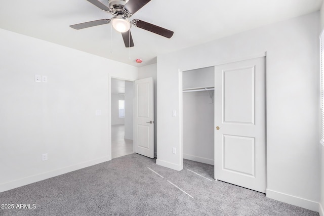 unfurnished bedroom with a closet, ceiling fan, and light colored carpet