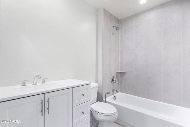 full bathroom with toilet, vanity, and tiled shower / bath