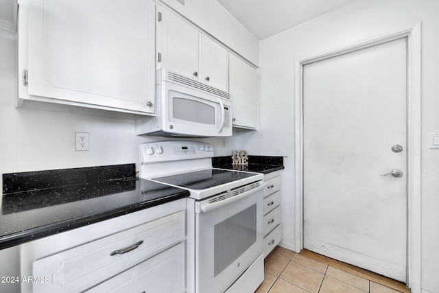 kitchen featuring white appliances, white cabinetry, and light tile patterned flooring